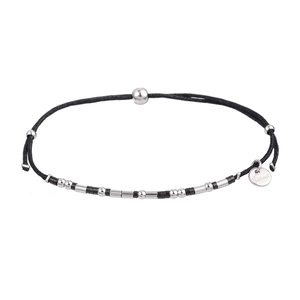 Detailed shot of Morse code woven bracelet with stainless steel beads and S.Steel tag