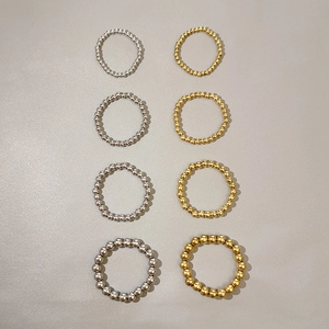 Set of 8 gold and silver stainless steel beaded rings in various bead sizes