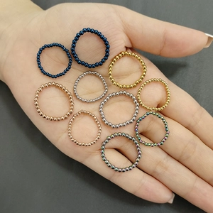 Macro shot of assorted colorful stainless steel beaded elastic rings on a palm display