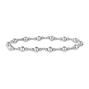 Macro detail of silver stainless steel beaded bracelet featuring alternating bead sizes