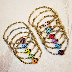 Colorful ladybug charm bracelets with stainless steel beads in assorted vibrant colors