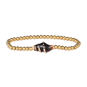 Detailed shot of ocean-themed gold beaded bracelet with a spiral shell charm accent