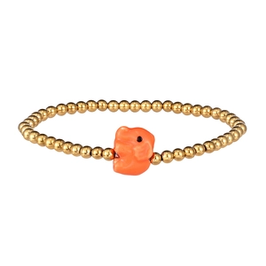 Detail of beaded bracelet with golden beads and a cute orange elephant charm