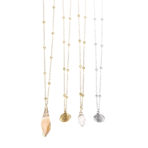 Set of four beach-themed conch and shell pendant necklaces in gold and silver finishes