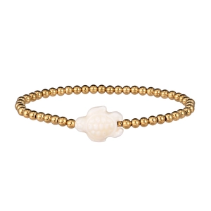 Detail of beaded marine bracelet featuring a white sea turtle and gold finish beads