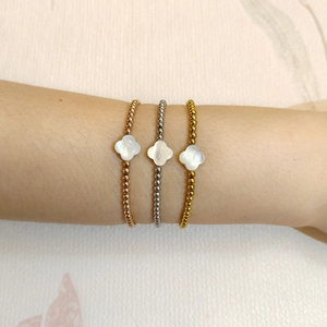 Three-piece stackable four-leaf clover beaded bracelets in gold, silver, and rose gold