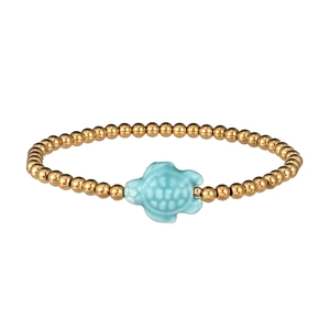 Detail of beaded gold bracelet featuring a light blue sea turtle charm with textures