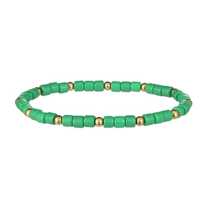 Dettaglio di perline cilindriche verdi e perline tonde dorate sul bracciale elastico