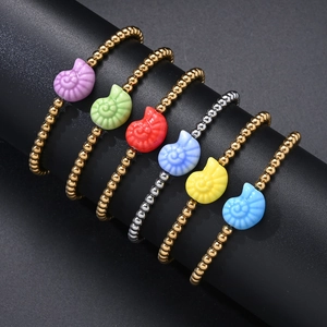 Detail of colorful ceramic shell pendants on titanium steel beaded bracelets
