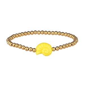 Close-up of a gold-beaded bracelet featuring a bright yellow shell charm on white background