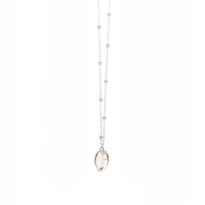 Detail of silver shell pendant necklace with small metal beads on a minimalist chain