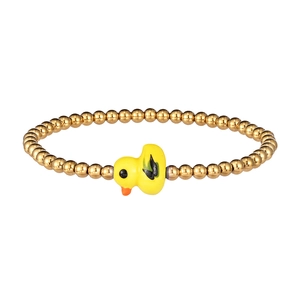 Close-up of golden beaded stretch bracelet featuring a small yellow duck charm