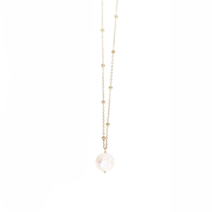Close-up of golden beaded chain necklace with round iridescent shell pendant detail