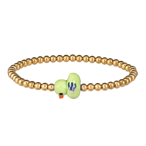 Close-up of golden beaded bracelet featuring a cute light green ceramic duck pendant