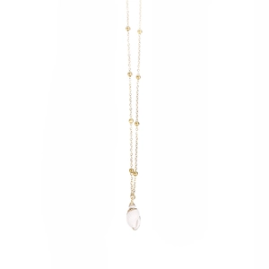 Detail of gold beaded chain necklace featuring a natural white seashell pendant