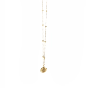 Close-up of golden shell pendant on a fine beaded chain necklace for beach style