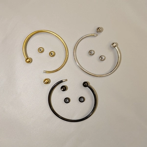 Detailed view of DIY stainless steel bangle with detachable threaded balls in gold, silver, and black