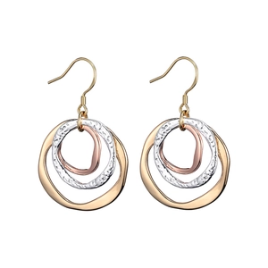Macro shot of tricolor triple hoop earrings with gold, silver, and rose gold hammered texture