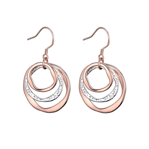 Detail of interlocking mixed metal rings with hammered texture and polished rose gold finish