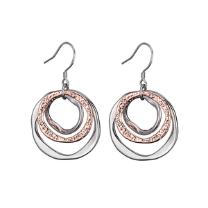 Detail of interlocking mixed metal rings with textured irregular hammered finish