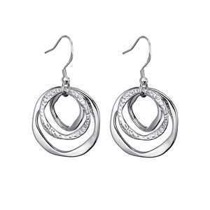 Detail of silver triple-hoop earrings featuring hammered inner texture and smooth outer rings