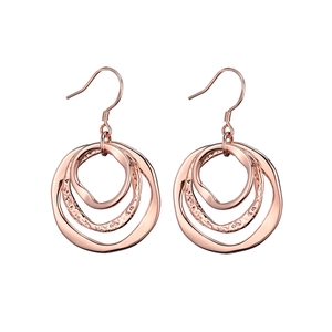 Detailed macro view of three-tier rose gold layered hoop earrings with hammered texture