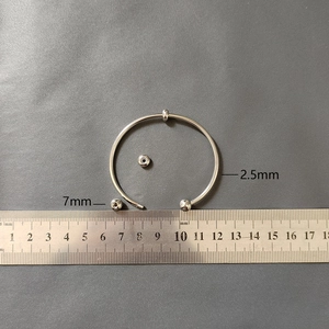 Detail of 2.5mm stainless steel flexible bangle with removable 7mm threaded beads