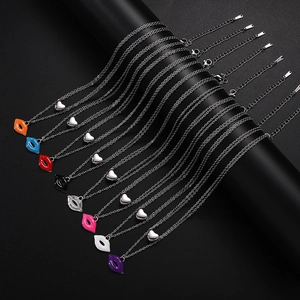 Detail of multi-color enamel heart and lip pendants on layered stainless steel chains