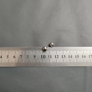Close-up of 4mm waterproof stainless steel round beads showing precise size measurement