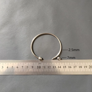 Detail view of 2.5mm stainless steel flexible bangle with 7mm threaded beads and steel ruler