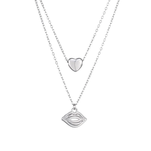 Close-up of double layer silver necklace featuring heart and lip pendants on fine chains