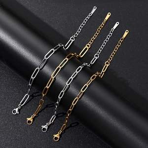 Detail of gold and silver paperclip chain bracelets with lobster clasps and extenders