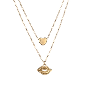 Detail view of double-layer gold necklace featuring mini heart and red lip pendants