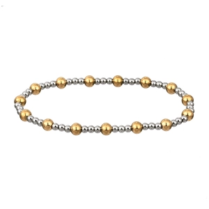 Detail of 18K gold and silver stainless steel beaded bracelet with elastic design