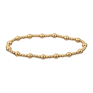 Detail of 18K gold-plated stainless steel bracelet featuring polished beads of varying sizes