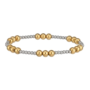 Close-up of dual-tone 18K gold and silver stainless steel beaded elastic bracelet