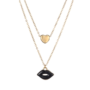 Detailed view of layered gold chain with heart pendant and black enamel lip charm