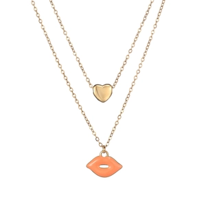 Close-up of double-layer gold necklace featuring heart pendant and red lip charm