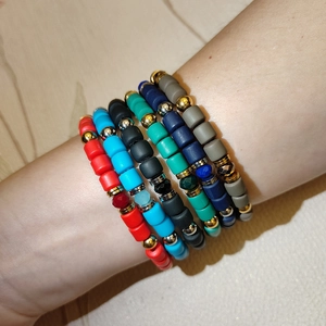 Set of 6 colorful matte clay cylinder bead elastic bracelets with gold metal accents