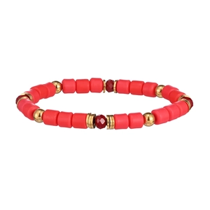 Detailed shot of red cylindrical polymer clay beads and gold metal spacers on elastic bracelet