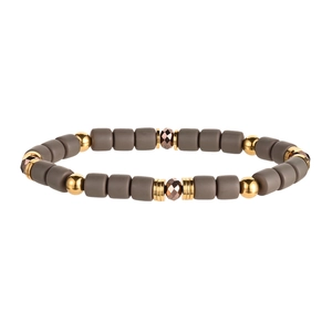 Detail of matte gray cylinder beads and polished gold accents on elastic bracelet