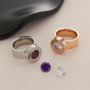 Detail of silver and rose gold zircon rings with classic Greek key pattern and loose stones