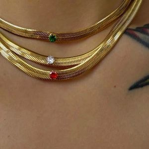 Three-piece titanium gold herringbone chain necklaces with green white and red gems
