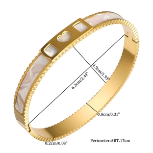 Detailed dimensions of gold titanium steel bangle with heart shell inlay and jagged edges