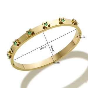 Detailed view of gold star bracelet with green zircon and 60mm inner diameter size