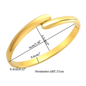 Detail view of 18K gold plated twisted bangle with dimensions 6cm x 5.1cm