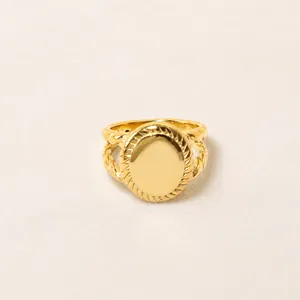Detail of 18K gold-plated stainless steel signet ring with braided rope texture