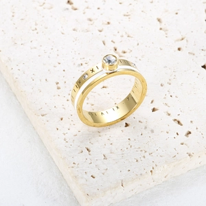 Gold Roman numeral ring with white enamel band and sparkling round center crystal