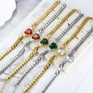 Detail of heart-shaped zircon bracelets with cuban chains in gold and silver finish
