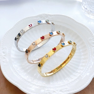 Three-color stainless steel heart bangles in silver, gold, and rose gold finishes